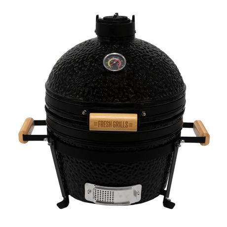 Black 16” Kamado BBQ oven with textured finish, wooden handles, and a temperature gauge, perfect for grilling and smoking food
