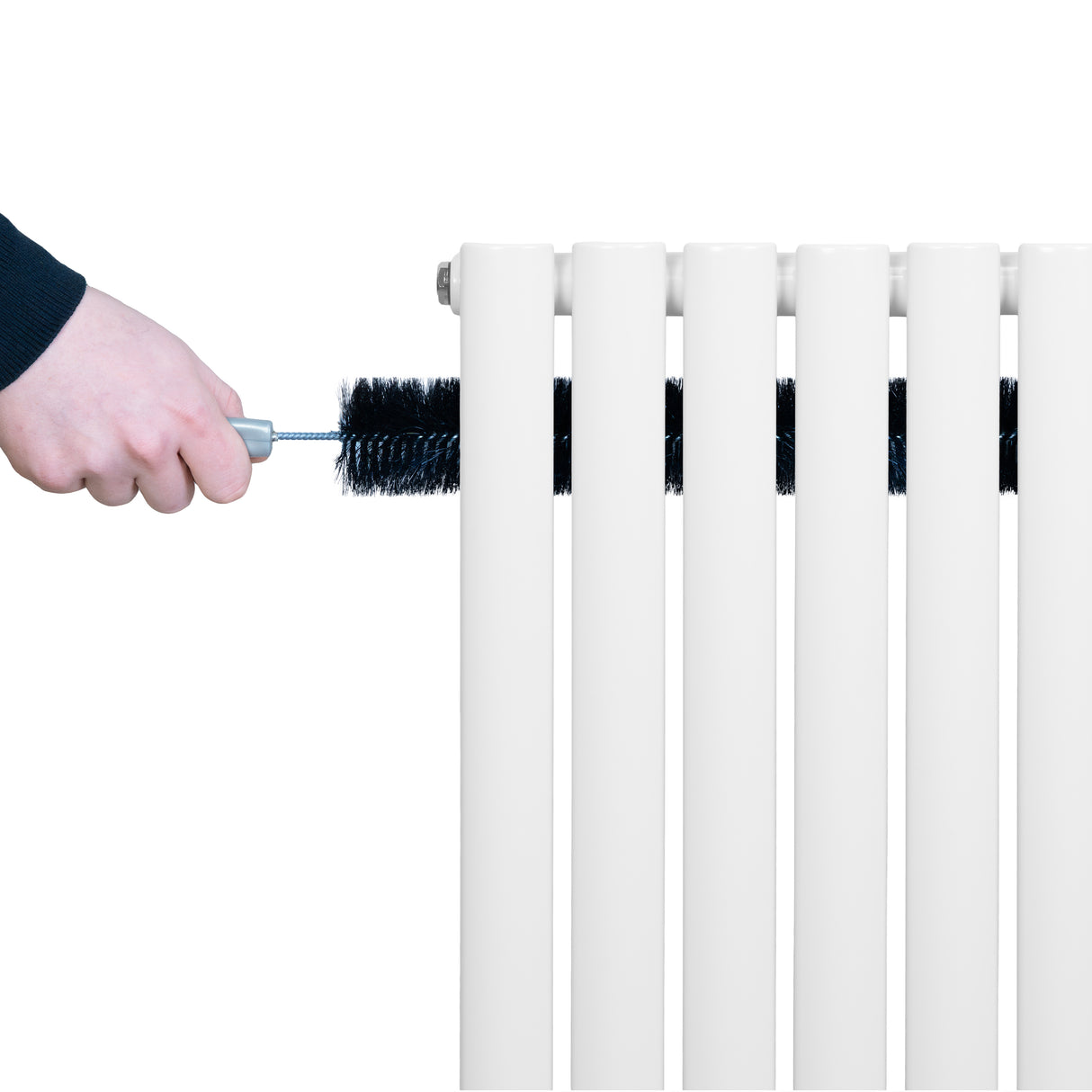 White oval single column radiator being cleaned with a brush, showcasing smooth surfaces and sleek design for efficient heating