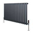 Oval single column radiator in anthracite grey, featuring sleek vertical tubes and polished valves, ideal for modern interiors