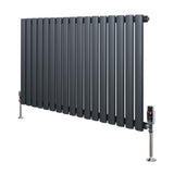 Oval single column radiator in anthracite grey, featuring sleek vertical tubes and polished valves, ideal for modern interiors