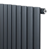 Anthracite grey oval single column radiator with sleek, smooth vertical bars and polished valve, ideal for modern interiors