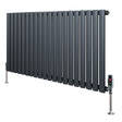 Oval single column radiator in anthracite grey, featuring sleek vertical tubes and polished valves, ideal for modern interiors