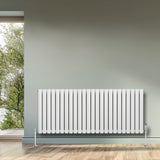 Sleek white oval single column radiator with vertical bars, mounted on a light gray wall, enhancing modern interior decor