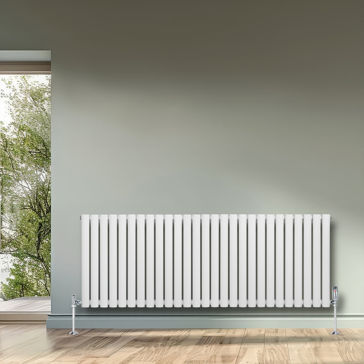 Sleek white oval single column radiator with vertical fins, installed against a light green wall, enhancing modern interior decor
