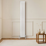 Sleek white oval single column radiator with chrome valves, positioned against a light wall, enhancing a modern living space
