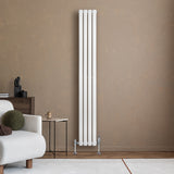 Sleek white oval single column radiator with polished valves, standing tall against a warm, textured wall in a modern living space