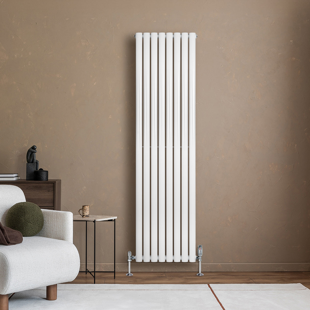 Sleek white oval single column radiator standing against a textured brown wall, complemented by stylish valves and modern decor
