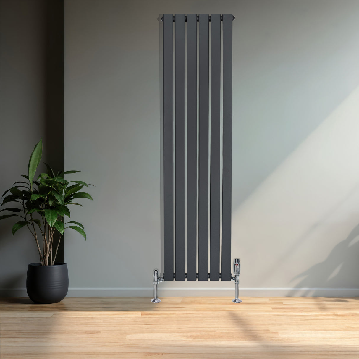 Sleek anthracite grey flat single column radiator with vertical lines, complemented by chrome valves, set against a modern interior backdrop