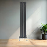 Sleek anthracite grey flat single column radiator with polished valves, standing tall against a minimalist interior and wooden floor