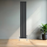 Sleek black flat single column radiator with chrome valves, standing tall against a light wall, enhancing modern interior decor