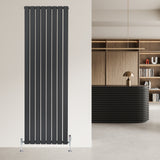 Tall anthracite grey flat single column radiator with sleek vertical lines, mounted on a light wall, complemented by modern decor