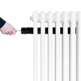 Traditional white 4 column radiator with a hand cleaning it using a brush, showcasing smooth, glossy finish and sturdy design