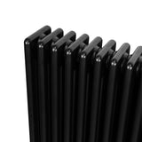 Traditional black 4 column radiator with smooth, rounded edges and a sleek, modern design, ideal for heating spaces efficiently