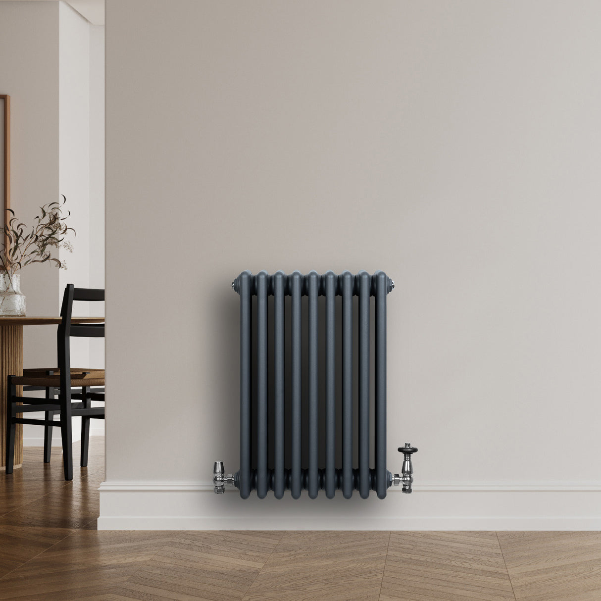 Traditional anthracite grey 4 column radiator with valves, featuring a sleek design and smooth, textured finish against a neutral wall