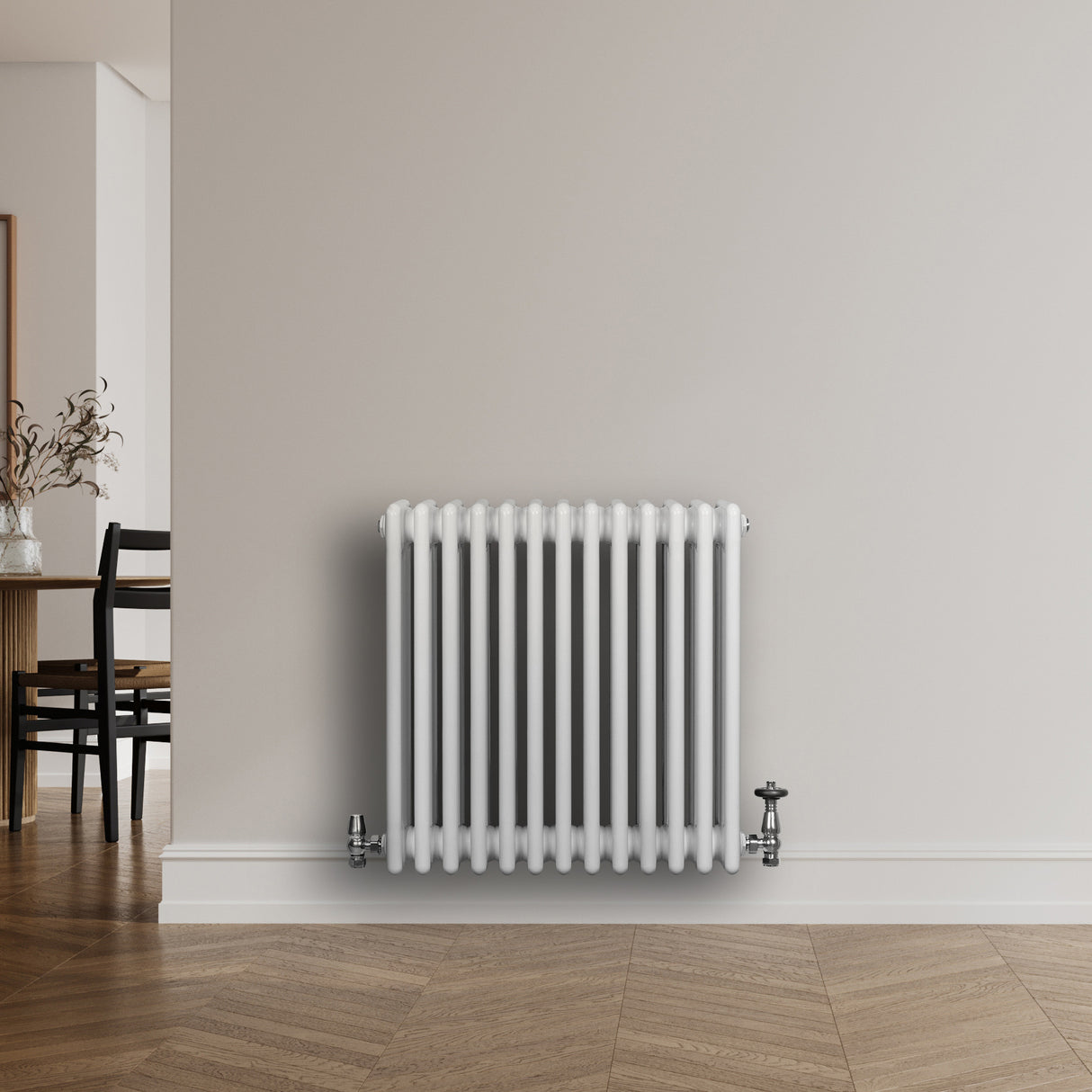 Traditional white 4 column radiator with chrome valves, featuring a sleek design and smooth finish, mounted on a light wall