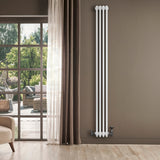 Traditional white 4 column radiator with sleek vertical design, mounted on a wall beside a large window and elegant curtains