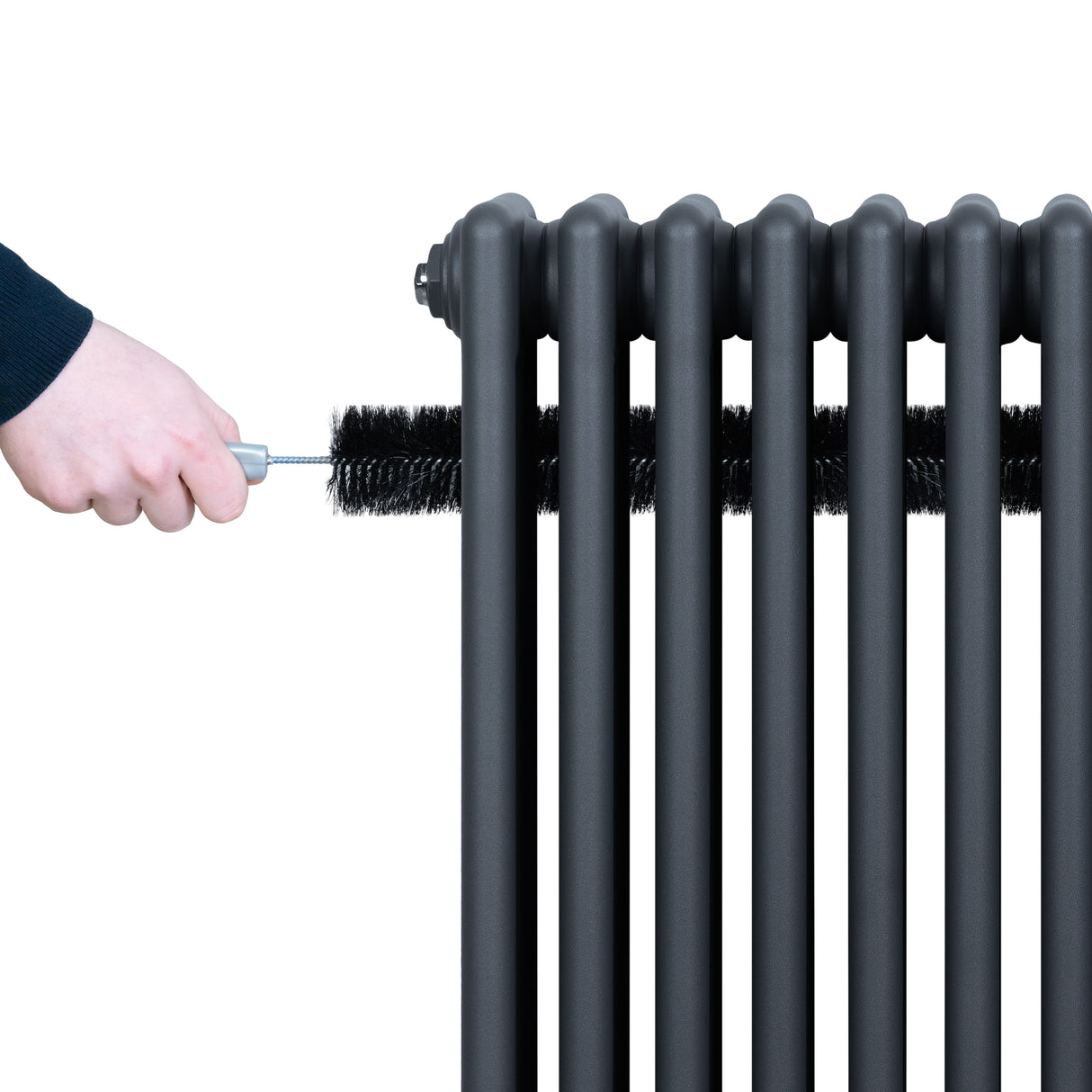 Anthracite grey traditional 4 column radiator with a hand using a brush for cleaning, showcasing its sleek, textured surface