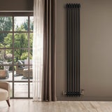 Traditional black 4 column radiator with brass valves, standing tall against a neutral wall, enhancing modern interior decor