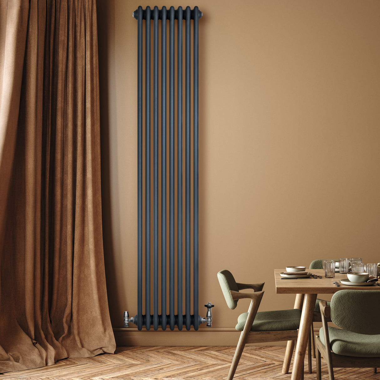 Traditional anthracite grey 4 column radiator with valves, mounted on a warm-toned wall, complementing a cozy dining area