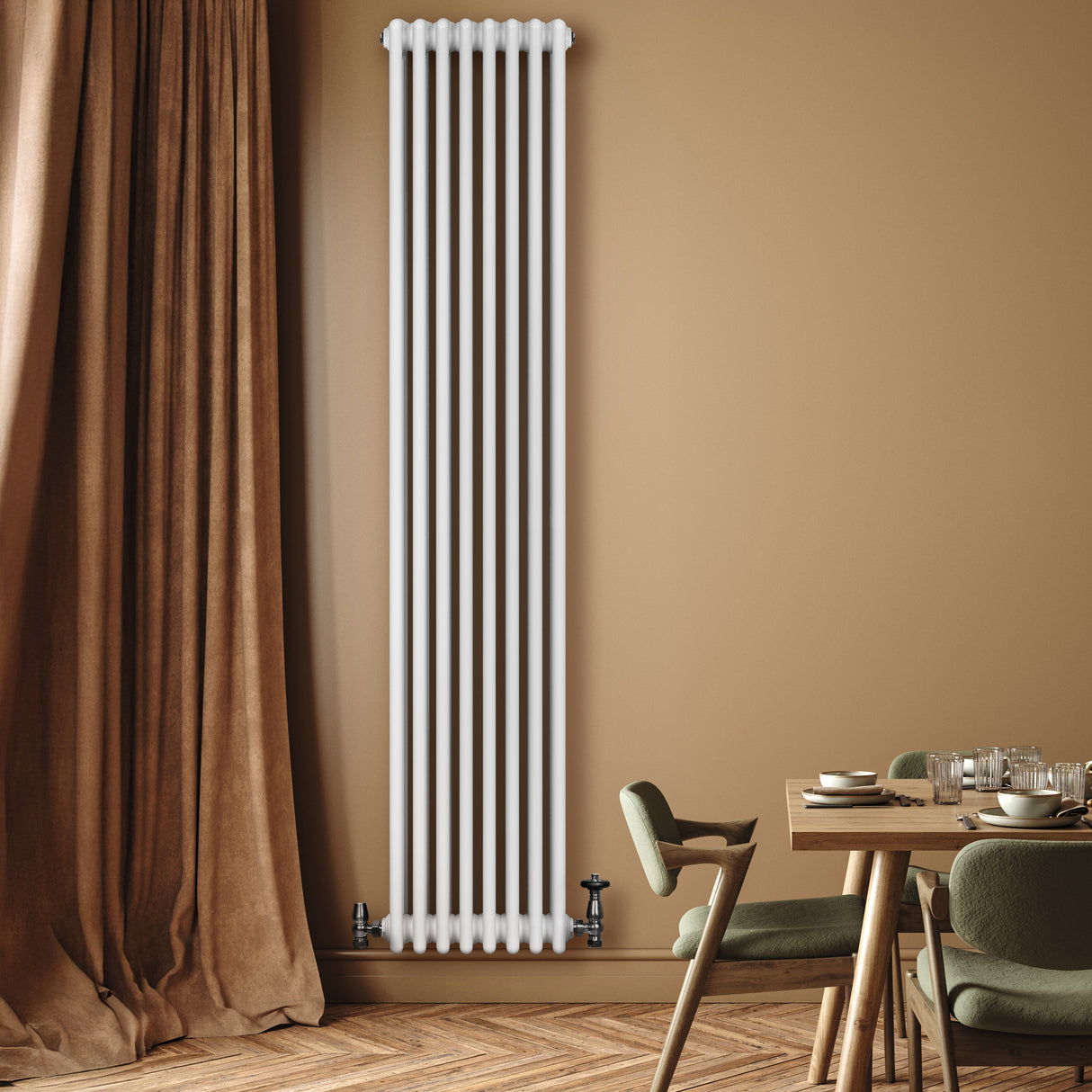 Tall white traditional 4 column radiator with valves, mounted on a warm-toned wall, beside a wooden dining table and soft curtains