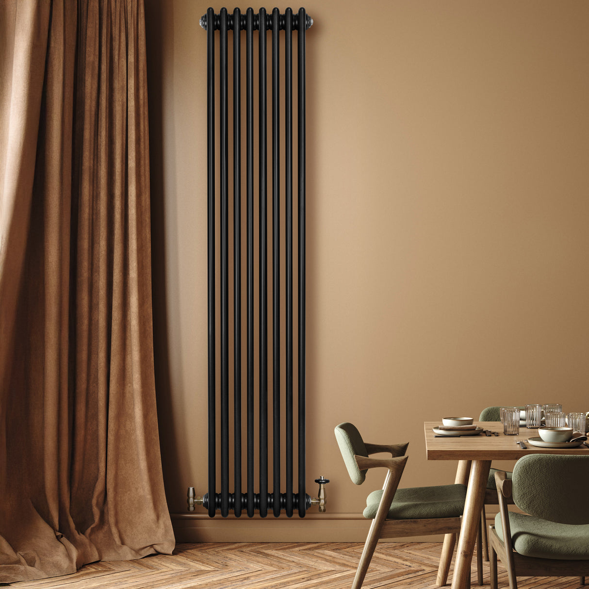 Sleek black traditional 4 column radiator mounted on a warm beige wall, complementing a stylish dining area with green chairs