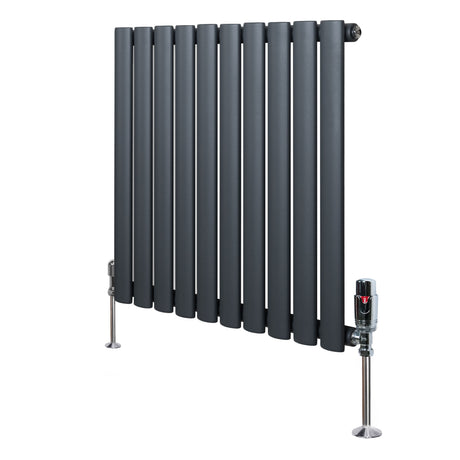Anthracite grey oval single column radiator with sleek vertical bars and polished valves, standing on sturdy metal feet