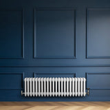 Traditional white 4 column radiator mounted on a deep blue wall, featuring a sleek, smooth finish and elegant design