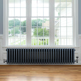 Traditional anthracite 4 column radiator, 300 x 1370mm, featuring a sleek design with a smooth finish, positioned under a large window