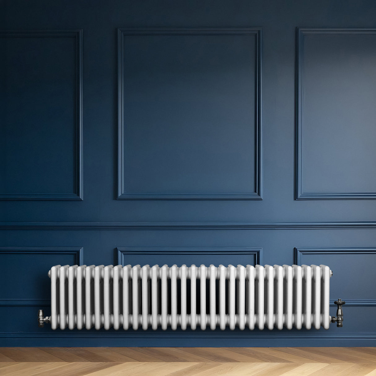 Traditional white 4 column radiator against a deep blue wall, featuring a sleek, smooth finish and classic design elements