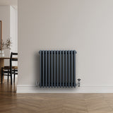 Traditional anthracite grey 4 column radiator, 600 x 605mm, featuring a sleek design and smooth finish, mounted on a wall in a modern interior