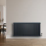 Traditional anthracite grey 4 column radiator, 600 x 1190mm, featuring a sleek design and ribbed texture, mounted on a light wall