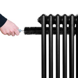 Black traditional 4 column radiator with a hand using a brush for cleaning, showcasing its sleek design and sturdy construction