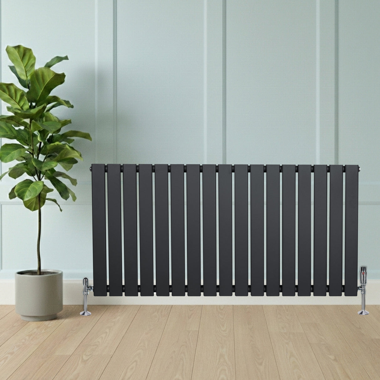 Flat single column radiator in anthracite grey, featuring sleek vertical slats, positioned against a light wall with a potted plant nearby