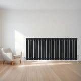 Sleek black flat single column radiator with vertical slats, positioned against a light wall, enhancing modern interior decor