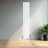 Sleek white flat single column radiator, 1600 x 280mm, mounted on a wall with chrome valves, complemented by a green potted plant