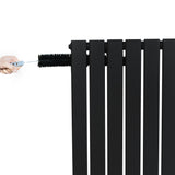Sleek black flat single column radiator with a hand adjusting the valve, showcasing its modern design and smooth finish