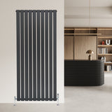 Sleek anthracite grey flat single column radiator with vertical slats, mounted on a modern wall in a stylish interior setting