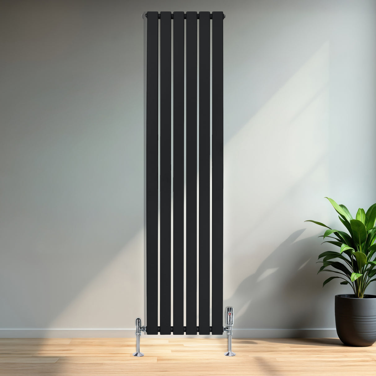Sleek black flat single column radiator, 1800 x 420mm, featuring vertical lines and modern design, mounted on a light wall with a plant nearby