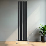 Sleek black flat single column radiator, 1800 x 420mm, featuring vertical lines and modern design, mounted on a light wall with a plant nearby
