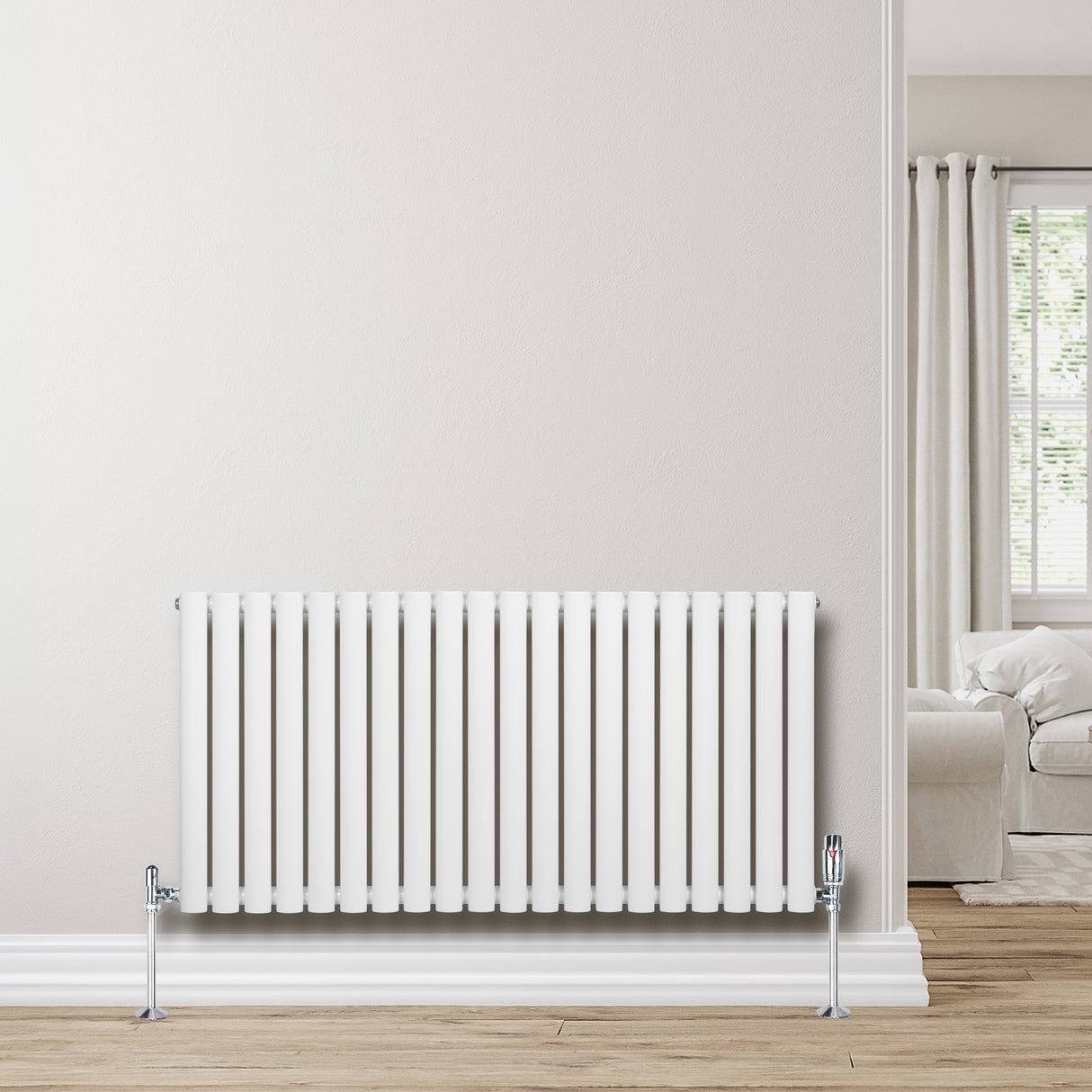Sleek white oval single column radiator, 600 x 1200mm, mounted on a light wall, enhancing modern interior decor with a clean design