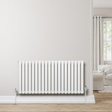 Sleek white oval single column radiator, 600 x 1200mm, mounted on a light wall, enhancing modern interior decor with a clean design