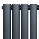 Anthracite grey oval single column radiator with a sleek matte finish, featuring four rounded vertical tubes for efficient heating