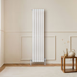 Sleek white oval single column radiator, 1600 x 360mm, mounted on a light wall, enhancing modern interior decor with elegant lines