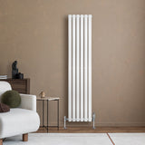 Sleek white oval single column radiator, 1600 x 360mm, mounted against a warm beige wall, enhancing modern interior decor