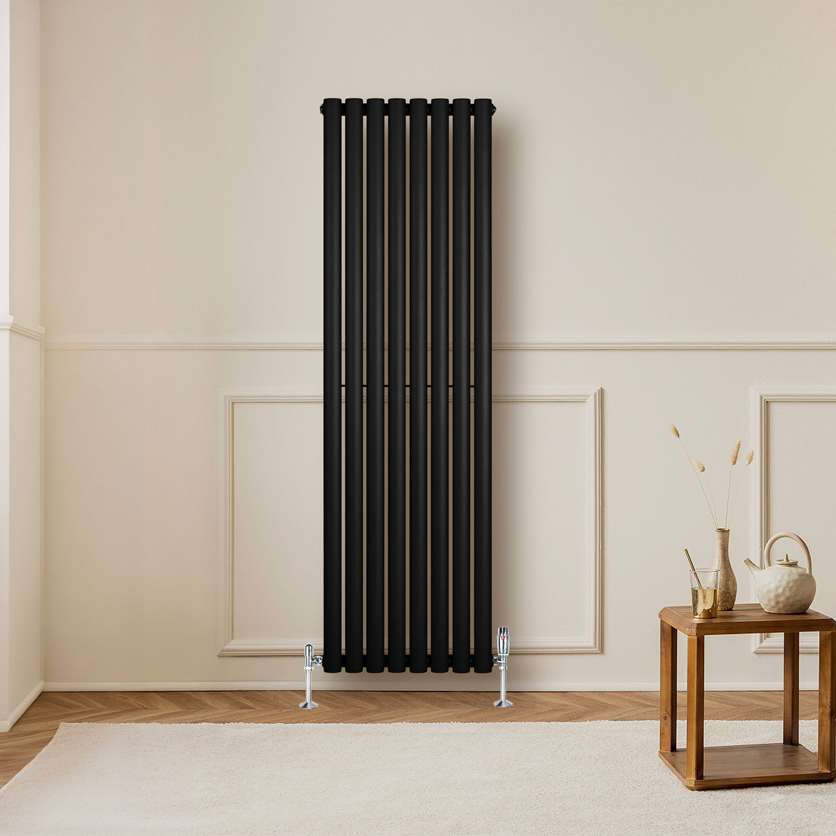 Sleek black oval single column radiator, 1600 x 480mm, mounted on a light wall, complementing a modern interior with wooden accents