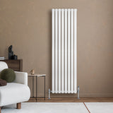 Sleek white oval single column radiator, 1600 x 480mm, mounted against a warm beige wall, enhancing modern interior decor