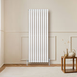 Sleek white oval single column radiator, 1600 x 600mm, featuring vertical bars and a modern design, mounted on a light wall