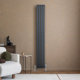 Sleek anthracite grey oval single column radiator, 1800 x 240mm, mounted on a textured beige wall, complementing modern decor