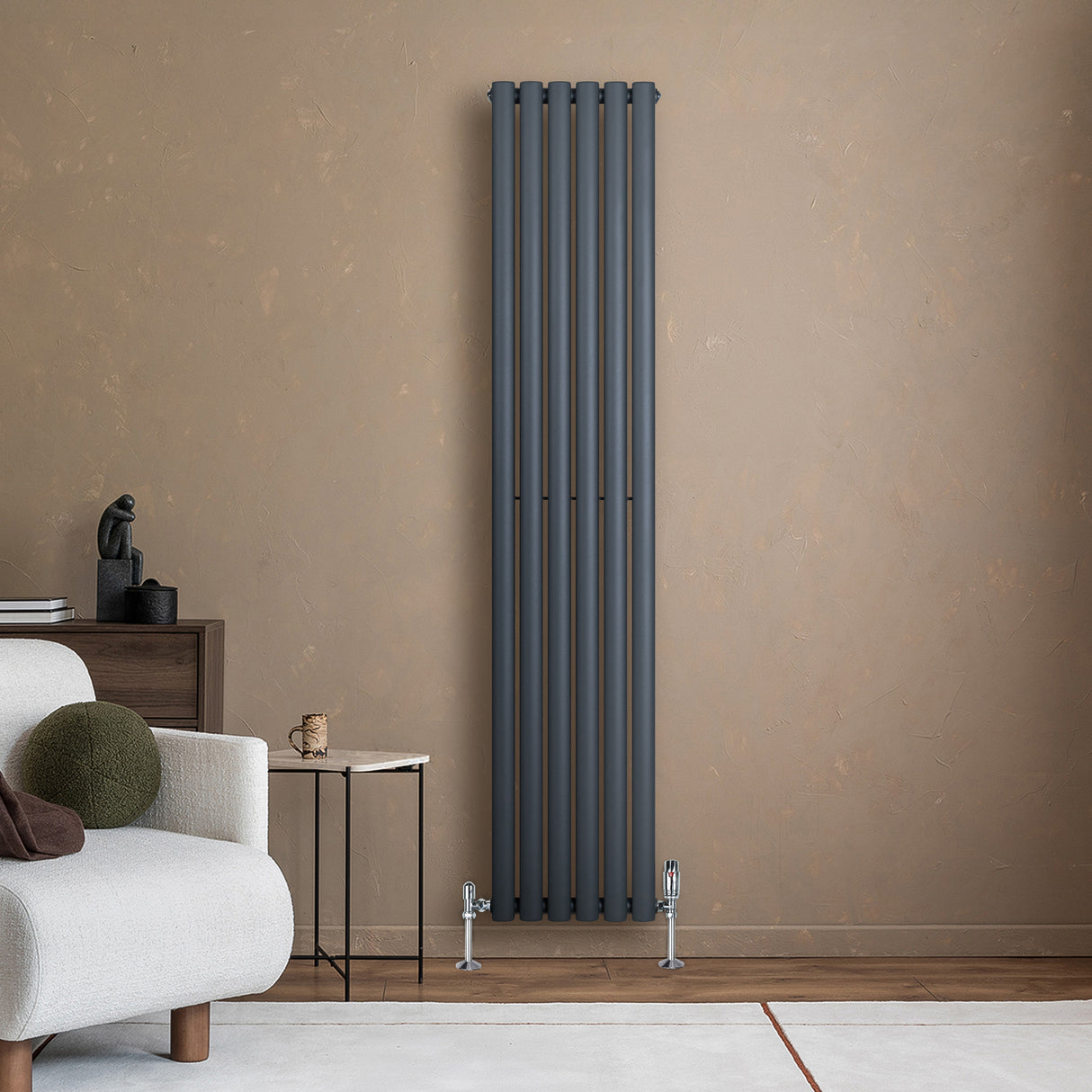Sleek anthracite grey oval single column radiator, 1800 x 360mm, mounted on a textured wall, enhancing modern interior decor