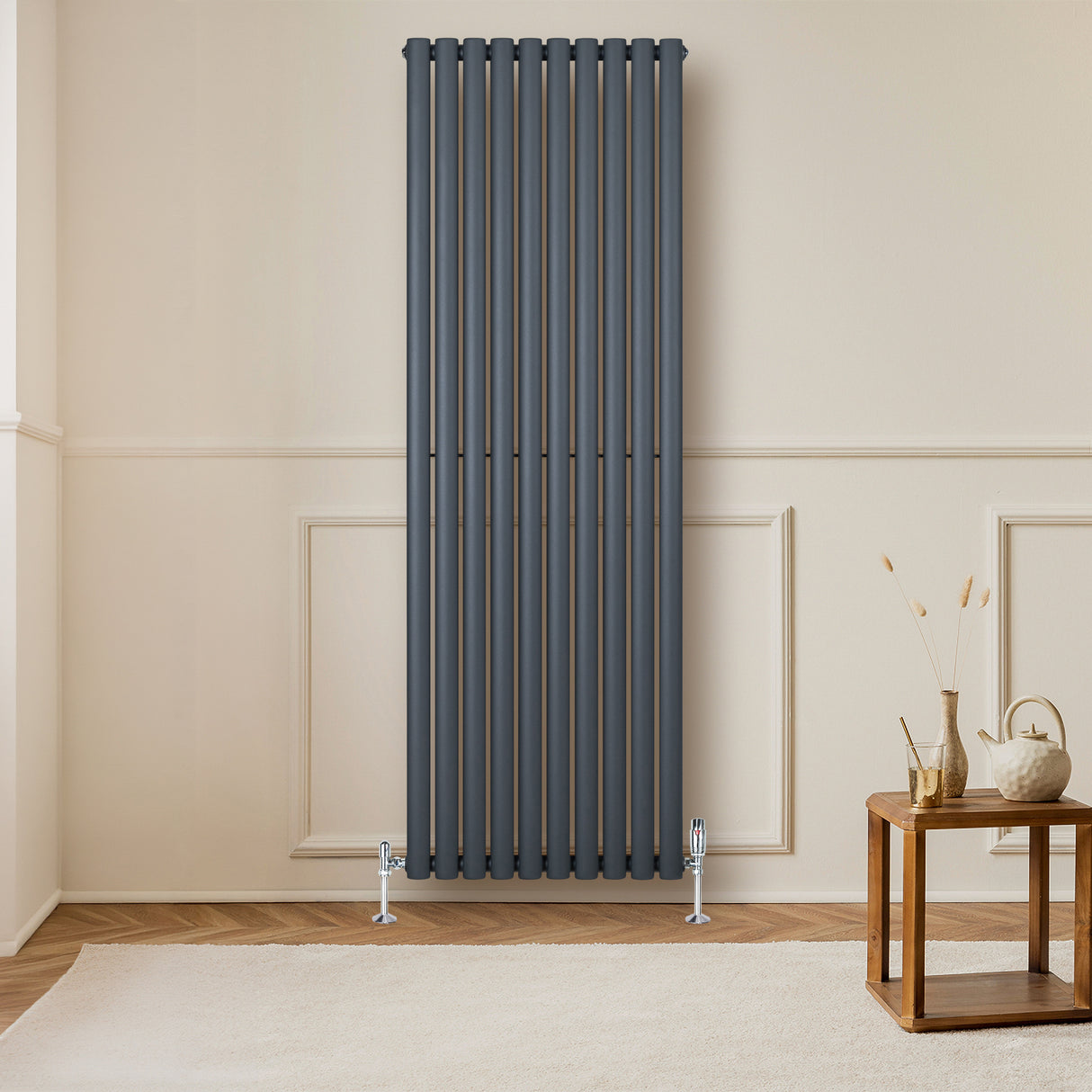 Sleek anthracite grey oval single column radiator, 1800 x 600mm, mounted on a light wall, enhancing modern interior decor